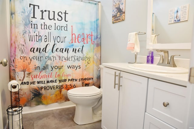 bathroom with toilet, tile patterned flooring, and vanity