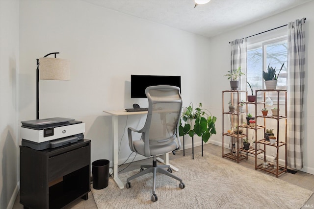 office space featuring light hardwood / wood-style floors and a textured ceiling