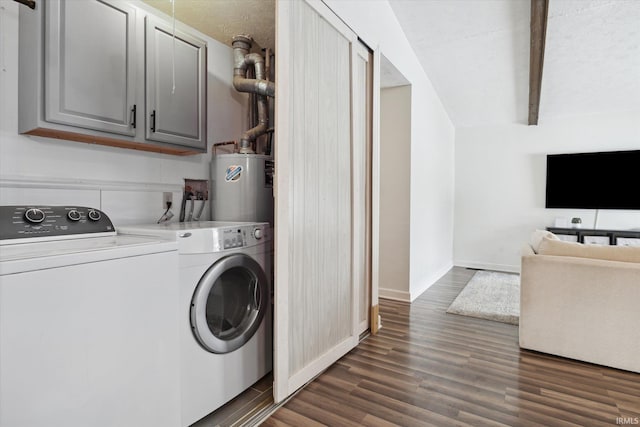 laundry room with water heater, dark wood-type flooring, cabinets, and washing machine and dryer