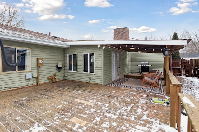 snow covered deck with grilling area