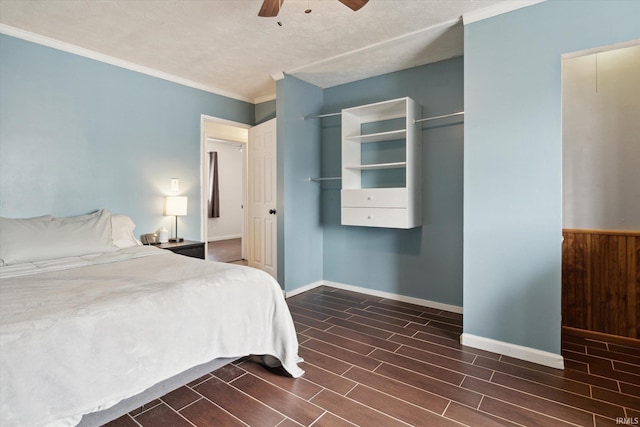 bedroom featuring dark hardwood / wood-style flooring, ceiling fan, and ornamental molding