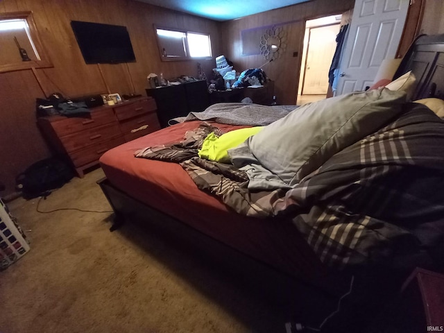 carpeted bedroom featuring wooden walls