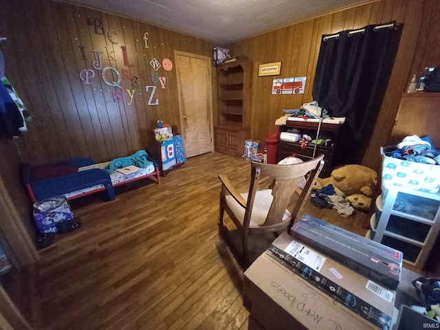 interior space with hardwood / wood-style flooring and wood walls