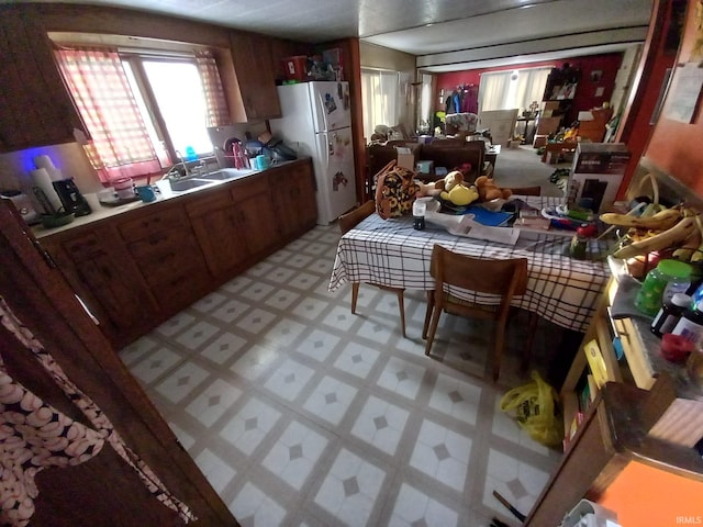 kitchen featuring white fridge and sink