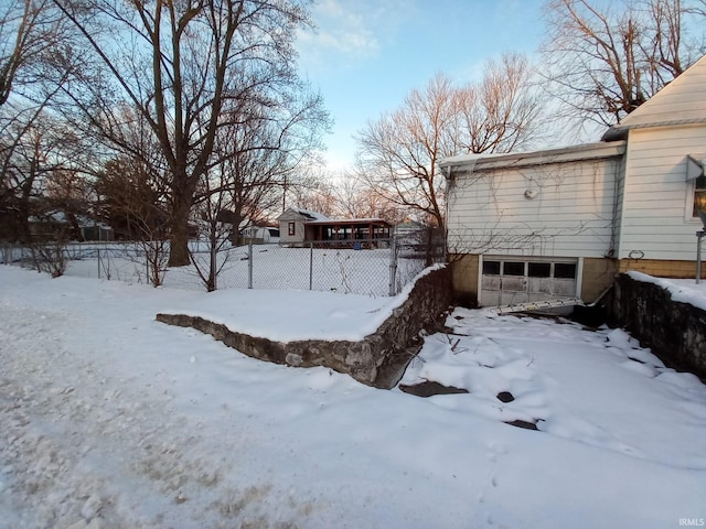 yard covered in snow with a garage