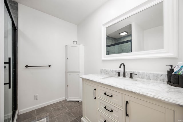 bathroom with vanity and a shower with door