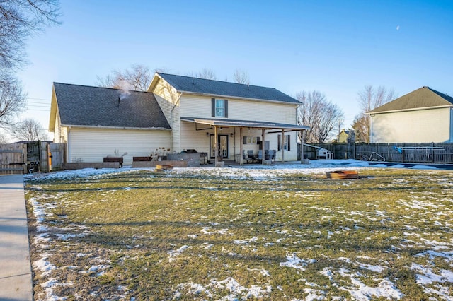 view of snow covered back of property