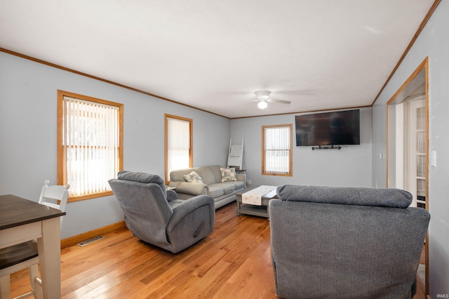 living room with ornamental molding, ceiling fan, and light hardwood / wood-style floors