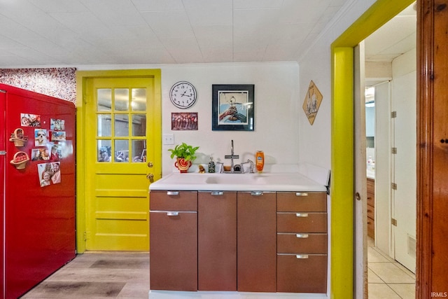 bathroom featuring crown molding, vanity, and hardwood / wood-style flooring