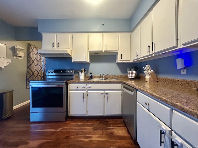 kitchen featuring appliances with stainless steel finishes, sink, white cabinets, and dark hardwood / wood-style flooring