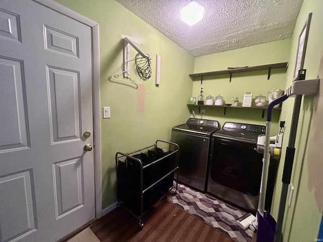 clothes washing area with dark hardwood / wood-style floors, independent washer and dryer, and a textured ceiling