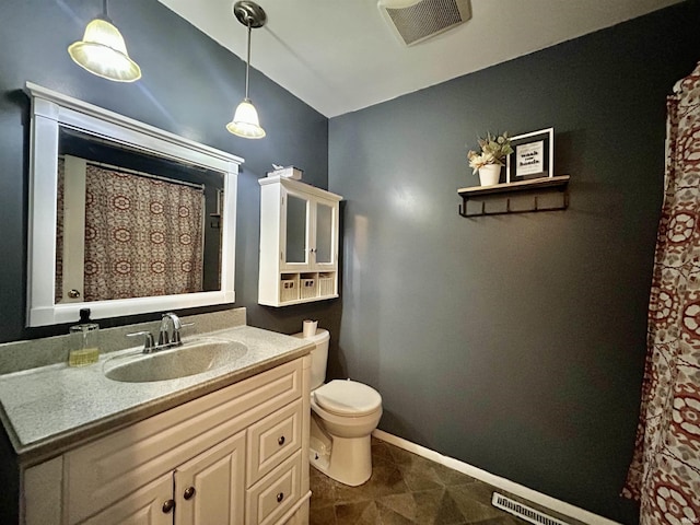 bathroom with vanity and toilet