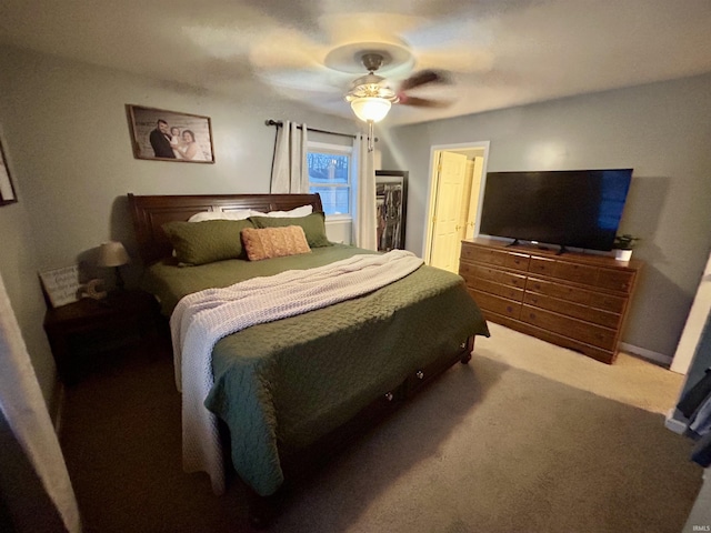 bedroom with ceiling fan, carpet, a closet, and a walk in closet