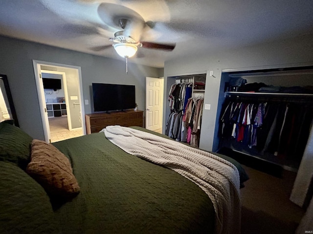 bedroom featuring multiple closets and ceiling fan