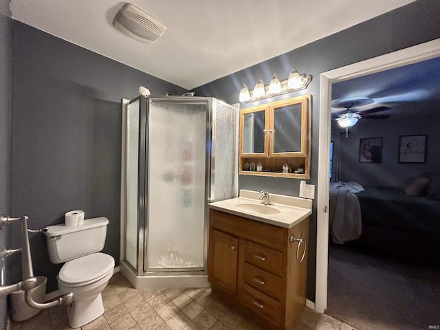 bathroom with an enclosed shower, vanity, and toilet