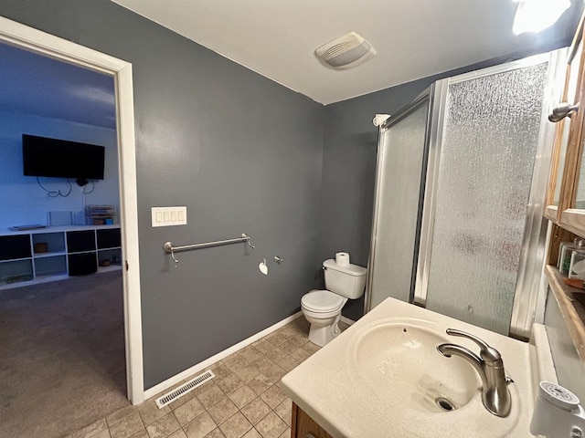 bathroom featuring vanity, an enclosed shower, and toilet