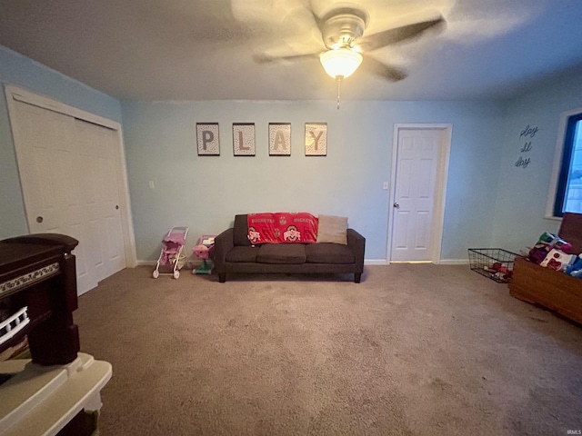 sitting room featuring ceiling fan and carpet flooring