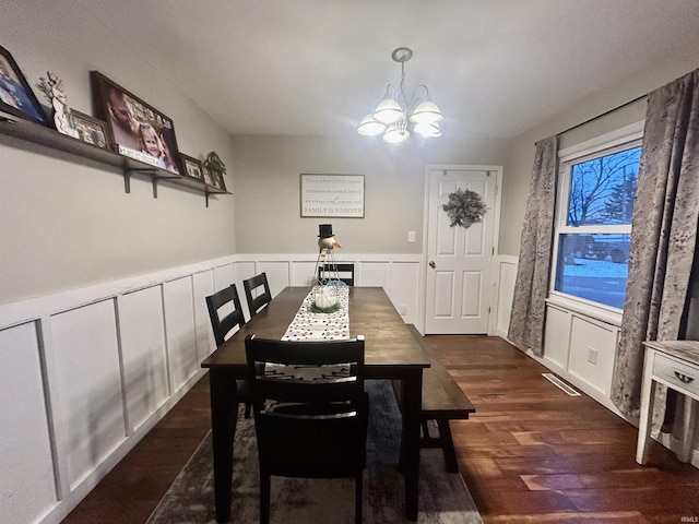 dining area featuring an inviting chandelier and dark hardwood / wood-style flooring