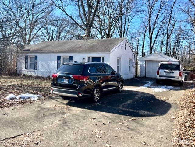 view of front of home with a garage and an outdoor structure