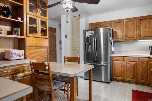 kitchen with light tile patterned flooring, ceiling fan, and stainless steel fridge with ice dispenser