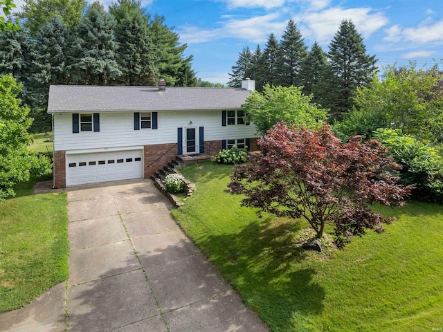 split foyer home with a garage and a front lawn