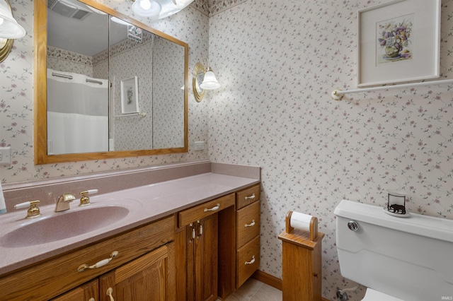 bathroom featuring tile patterned floors, toilet, curtained shower, and vanity