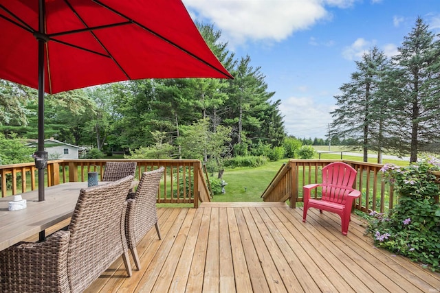 wooden terrace featuring a lawn