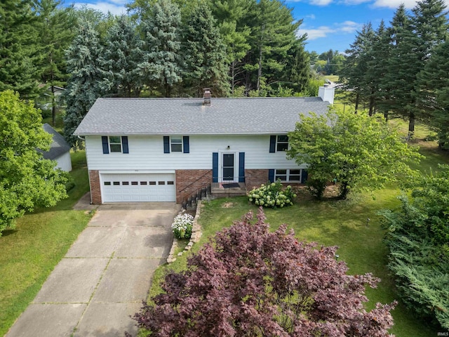 split foyer home featuring a garage and a front lawn