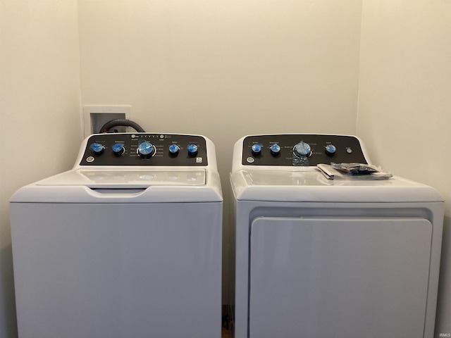 clothes washing area with washer and dryer