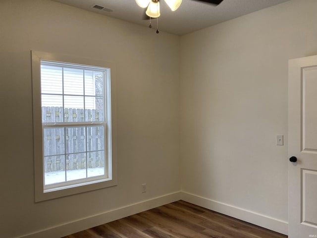 spare room with ceiling fan and dark hardwood / wood-style floors