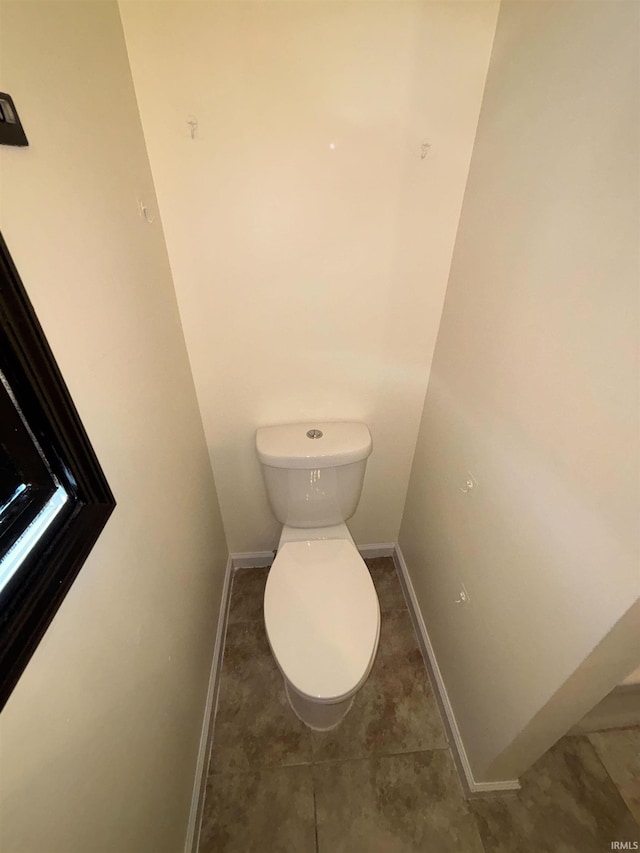 bathroom featuring toilet and tile patterned flooring