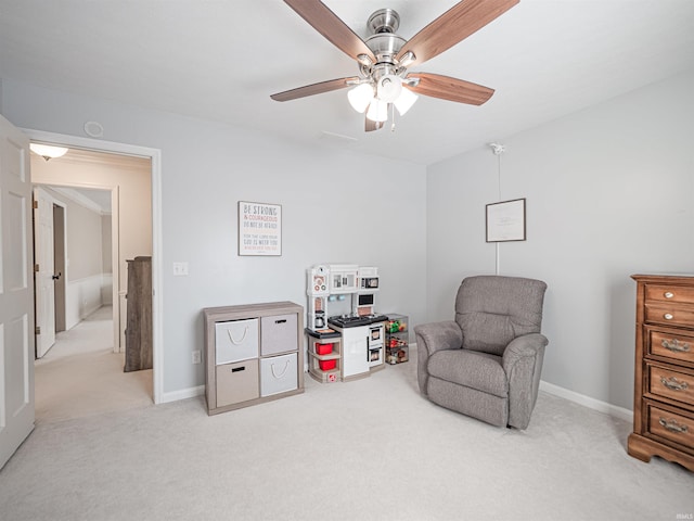 living area with ceiling fan and light carpet