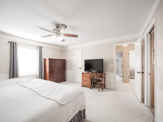 carpeted bedroom featuring ceiling fan and ornamental molding