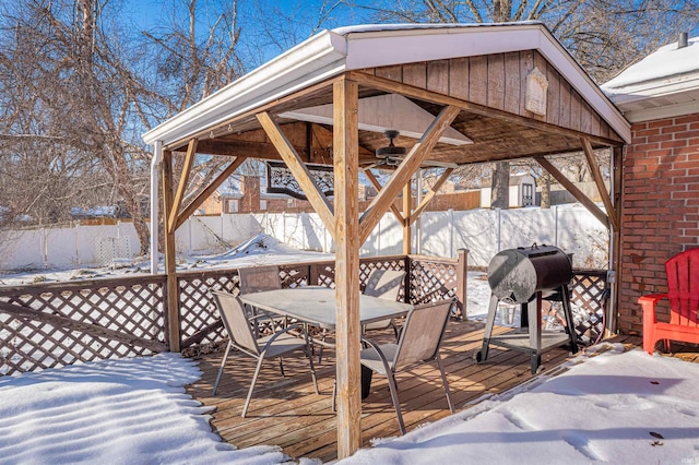 snow covered deck with ceiling fan, grilling area, and a gazebo