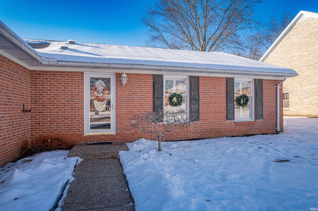 view of snow covered property entrance