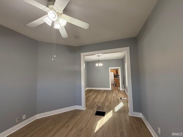 unfurnished room with hardwood / wood-style floors and ceiling fan