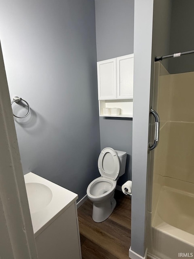 bathroom with vanity, toilet, and hardwood / wood-style floors