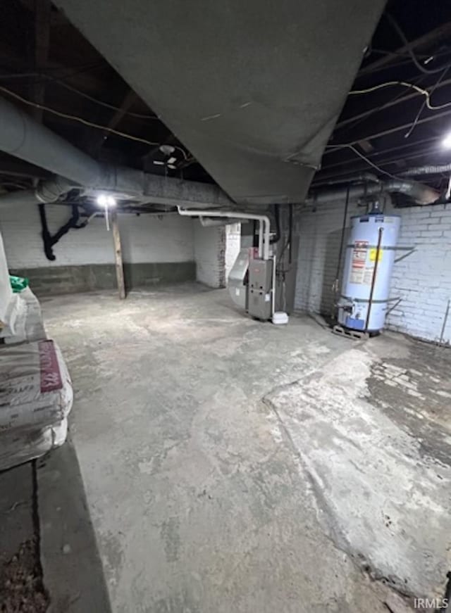 basement featuring gas water heater and heating unit