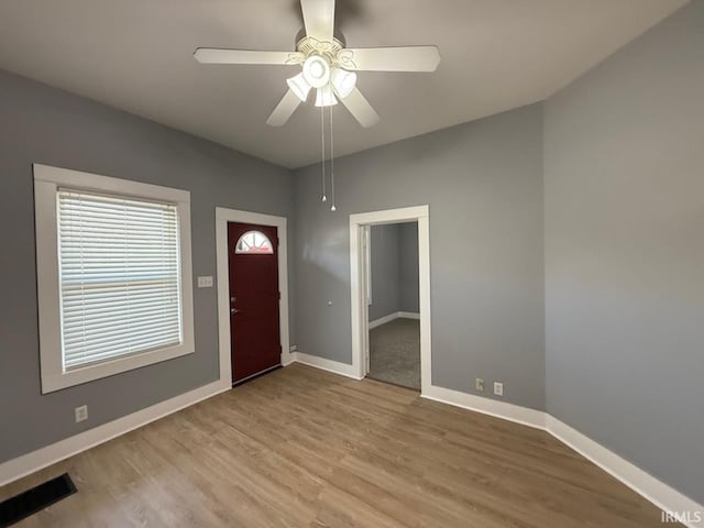 foyer with ceiling fan and light hardwood / wood-style floors