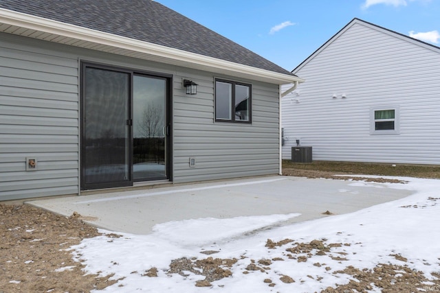 snow covered house with central air condition unit