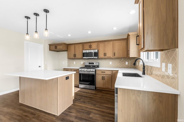 kitchen with pendant lighting, sink, dark wood-type flooring, stainless steel appliances, and a center island