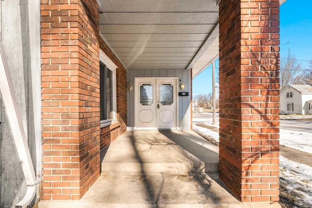 view of snow covered property entrance