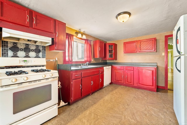 kitchen featuring sink, white appliances, and decorative backsplash