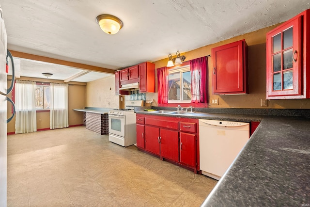 kitchen with beam ceiling, sink, and white appliances