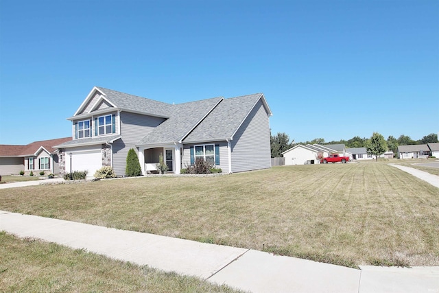 view of front of property with a garage and a front lawn