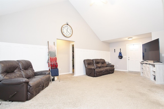 carpeted living room featuring high vaulted ceiling