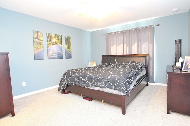 bedroom with light carpet and ceiling fan