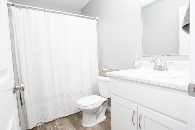 bathroom with vanity, wood-type flooring, and toilet