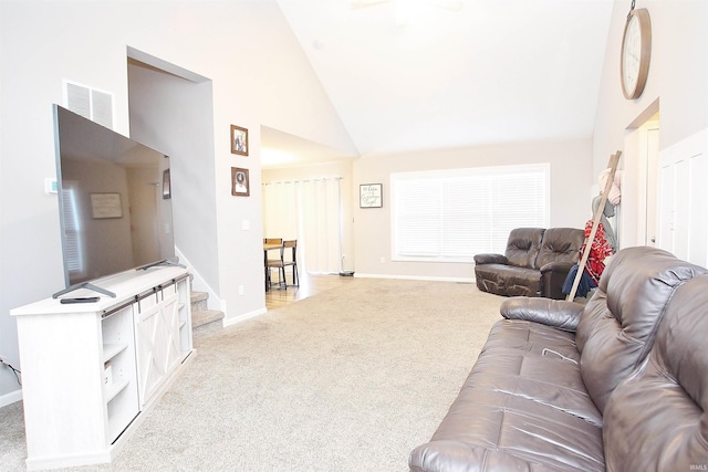 carpeted living room featuring high vaulted ceiling