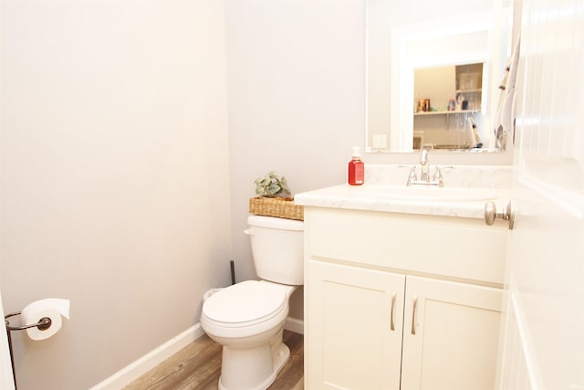 bathroom featuring hardwood / wood-style flooring, vanity, and toilet